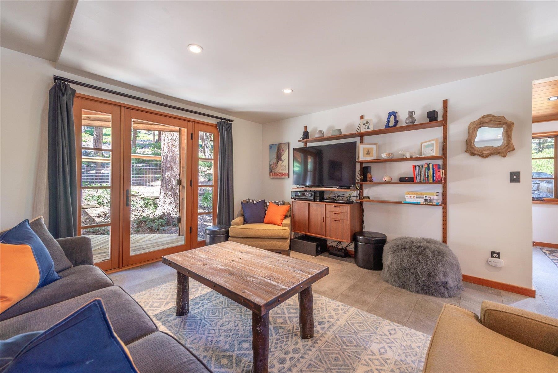 625 High Street Carnelian Bay, CA 96140 - Photo 7 of 22 a living room with furniture a flat screen tv and a large window
