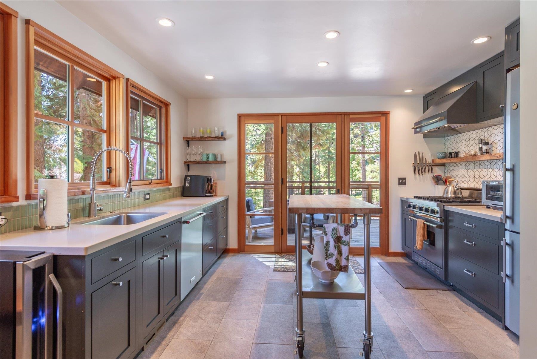 625 High Street Carnelian Bay, CA 96140 - Photo 9 of 22 a large kitchen with lots of counter space and windows