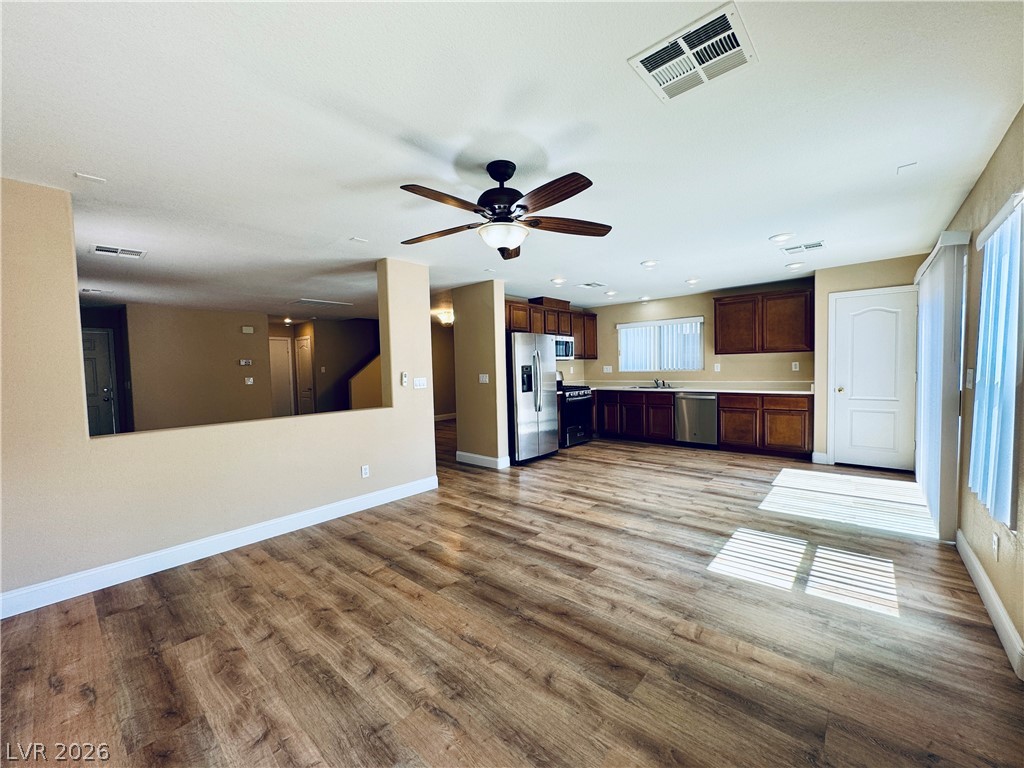 8617 Palomino Ranch Street Las Vegas, NV 89131 - Photo 8 of 27 An inviting open-concept layout unites the sun-kissed living area with a well-appointed kitchen.