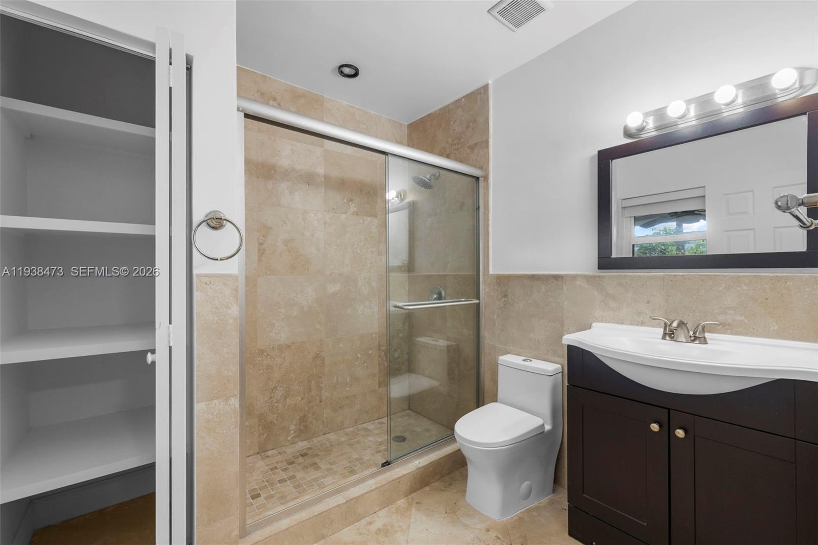 6086 Southwest 20th Street Miami, FL 33155 - Photo 18 of 35 a bathroom with a toilet a sink and shower