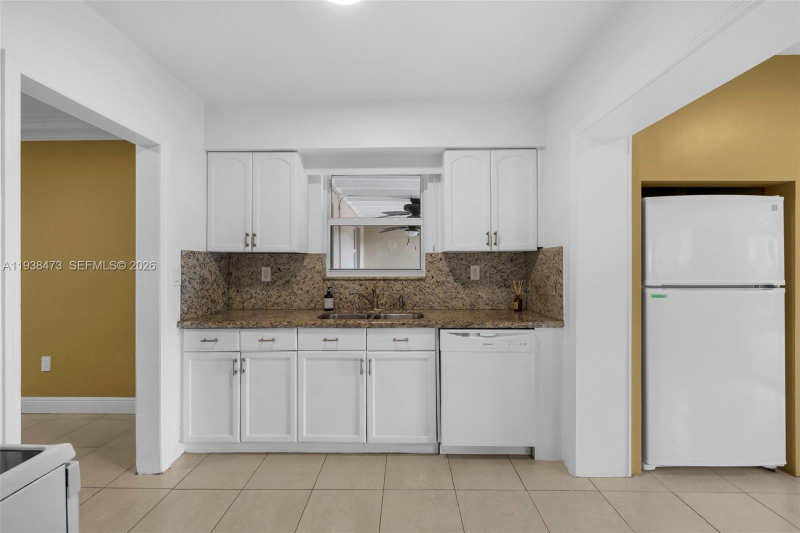 6086 Southwest 20th Street Miami, FL 33155 - Photo 10 of 35 a kitchen with stainless steel appliances granite countertop a refrigerator and a stove