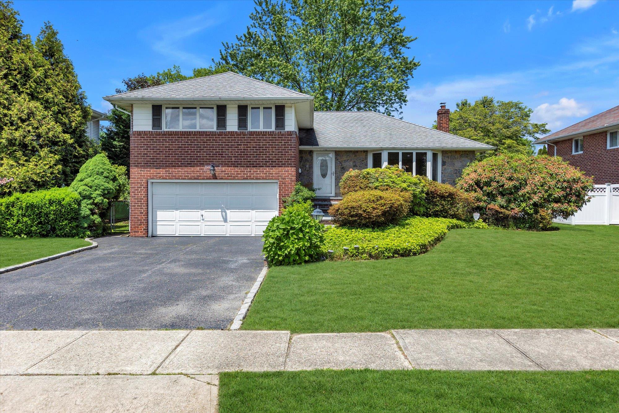16 Clearland Road Syosset, NY 11791 - Photo 1 of 1 a front view of a house with a yard