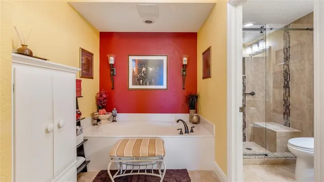 a en suite bathroom with a granite countertop sink and a mirror