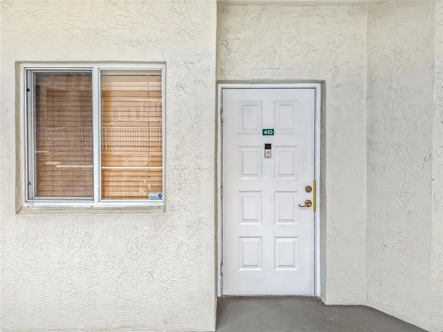 a kitchen with a table chairs refrigerator and cabinets