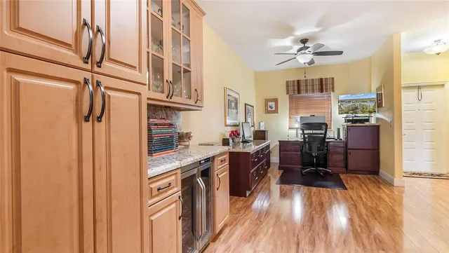 a kitchen with stainless steel appliances a refrigerator and wooden floor