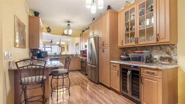 a dining room with furniture a chandelier and wooden floor