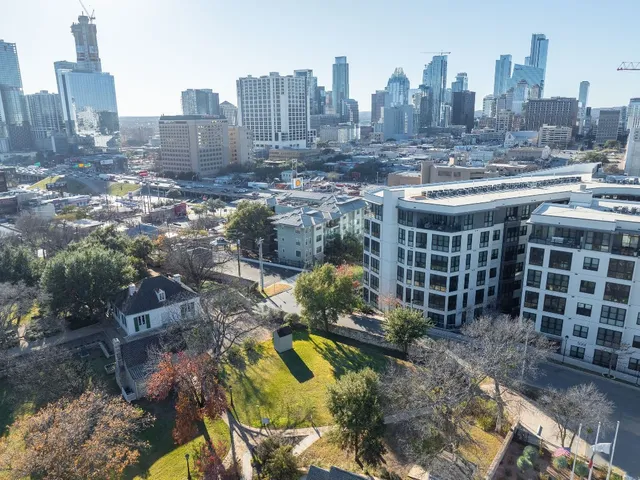 a view of a hallway with wooden floor and a potted plant