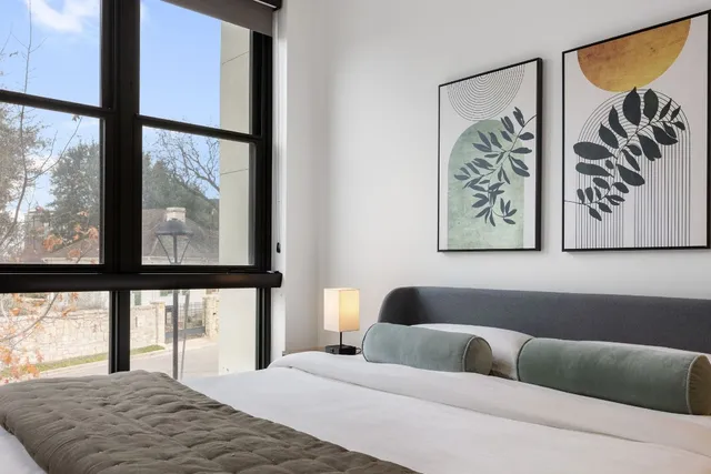 a bedroom with a bed and the view of bathroom