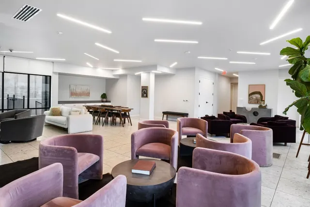 a reading room with furniture and large windows