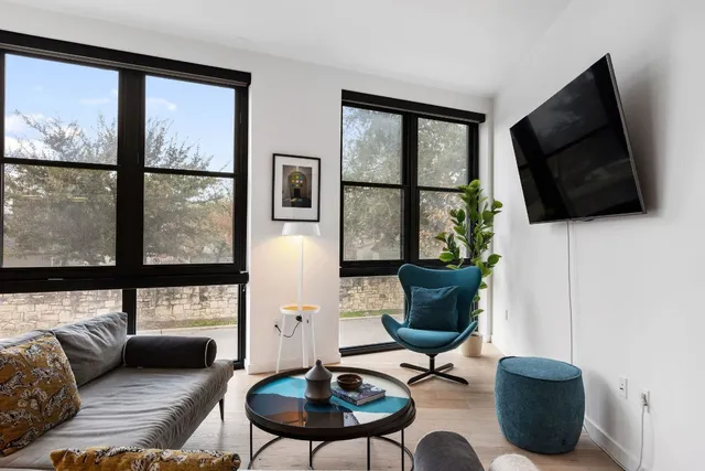 a living room with stainless steel appliances kitchen island granite countertop furniture and a view of kitchen