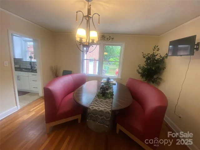 a view of a livingroom with furniture window and wooden floor
