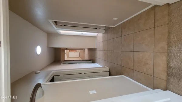 a bathroom with a tub sink and mirror