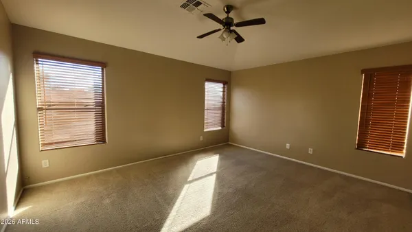 a view of a livingroom with a ceiling fan and window