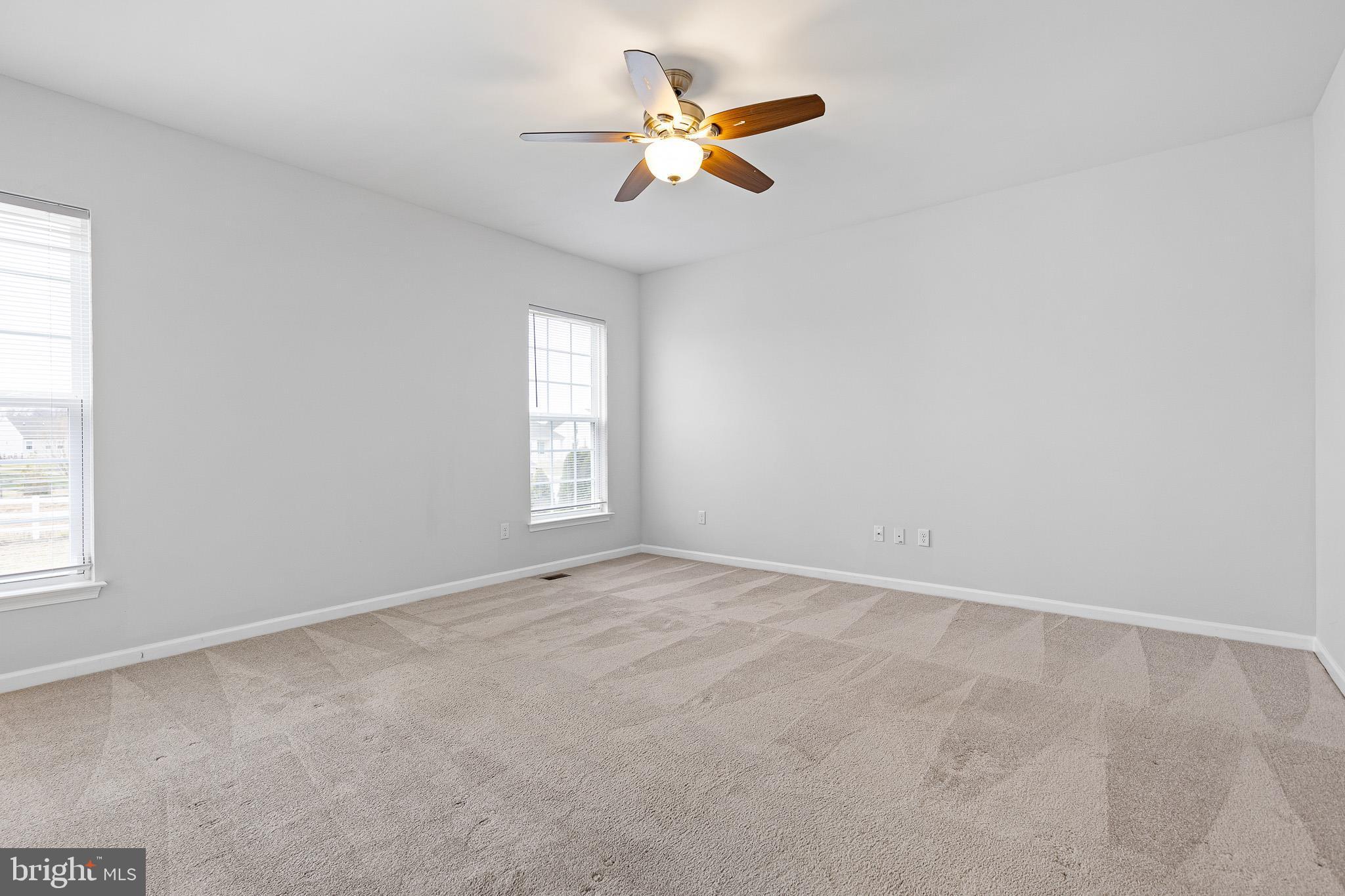413 Janets Way Townsend, DE 19734 - Photo 13 of 27 an empty room with windows and fan