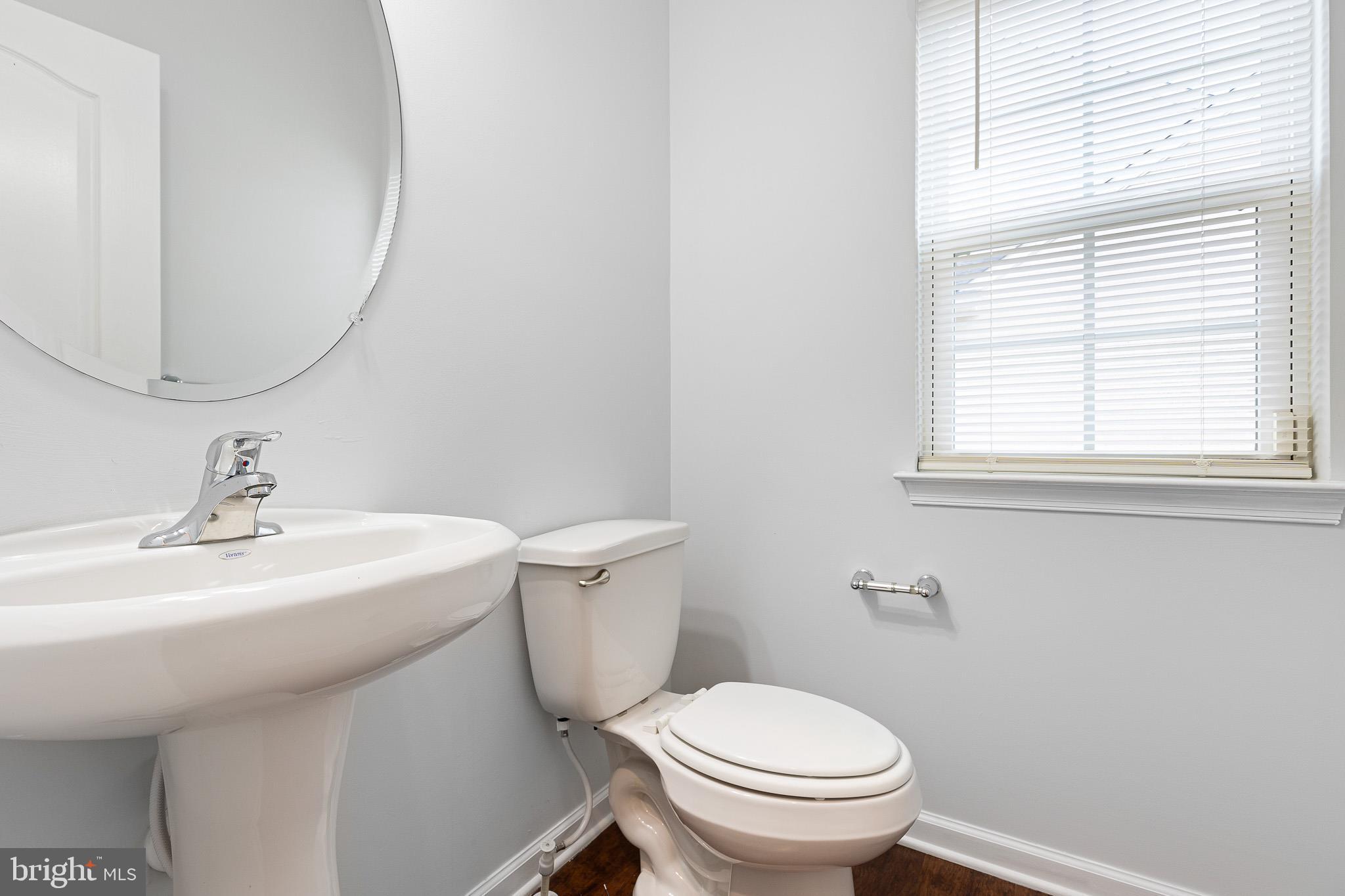 413 Janets Way Townsend, DE 19734 - Photo 14 of 27 a bathroom with a sink a toilet and a mirror