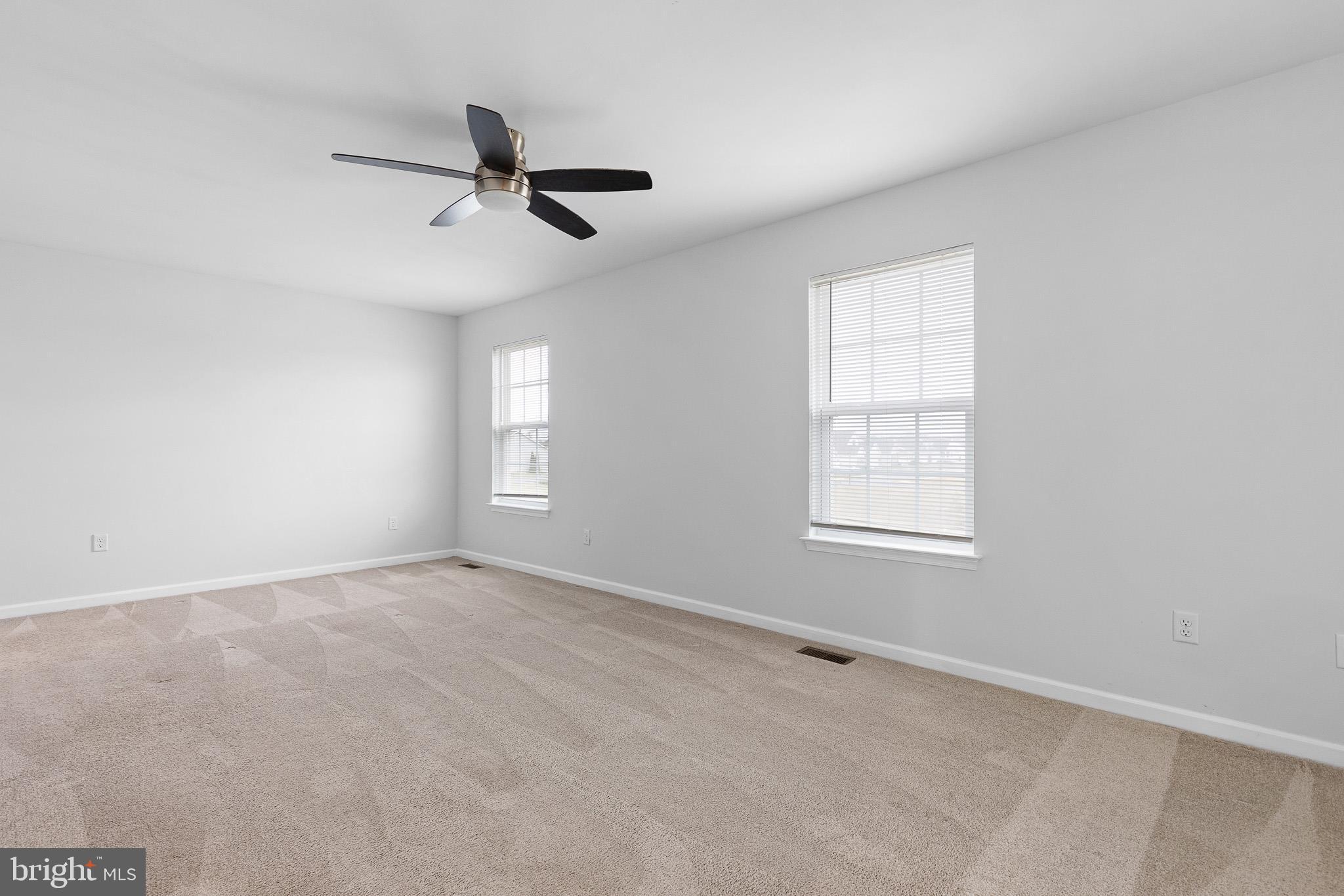 413 Janets Way Townsend, DE 19734 - Photo 20 of 27 an empty room with windows and fan