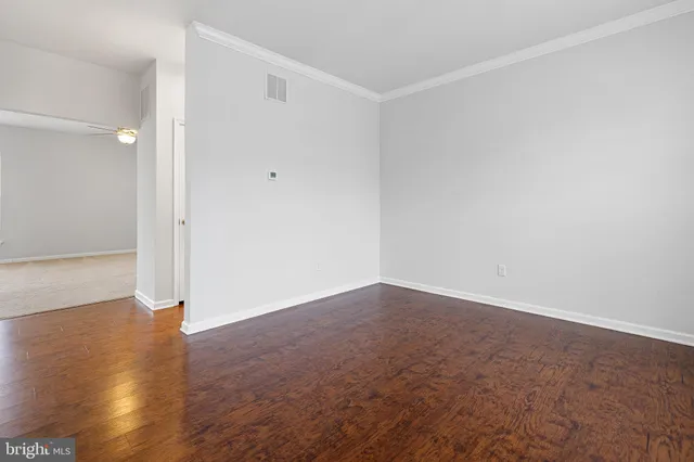 an empty room with wooden floor