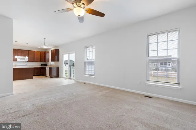 an empty room with windows and cabinet