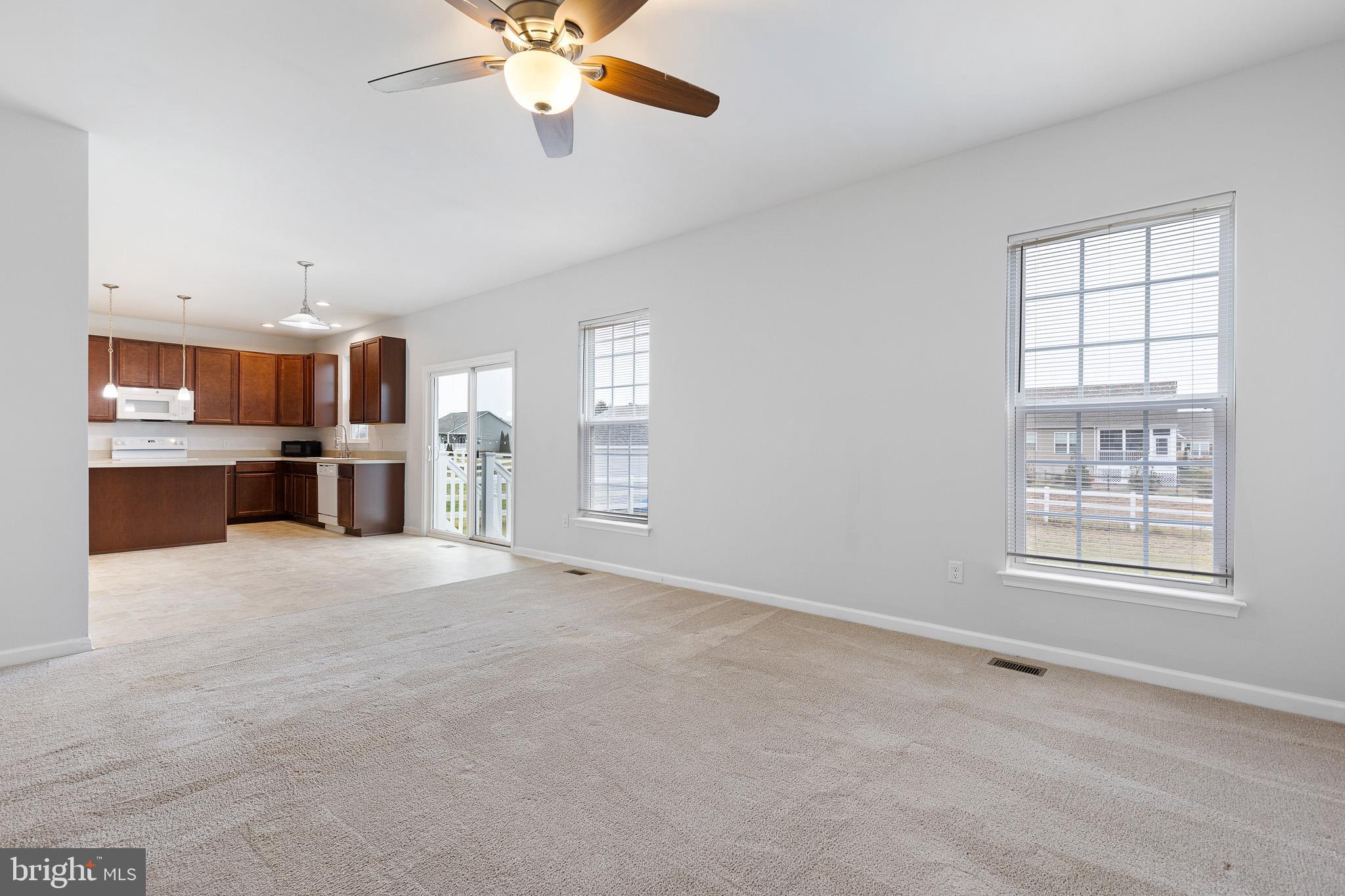 413 Janets Way Townsend, DE 19734 - Photo 8 of 27 an empty room with windows and cabinet