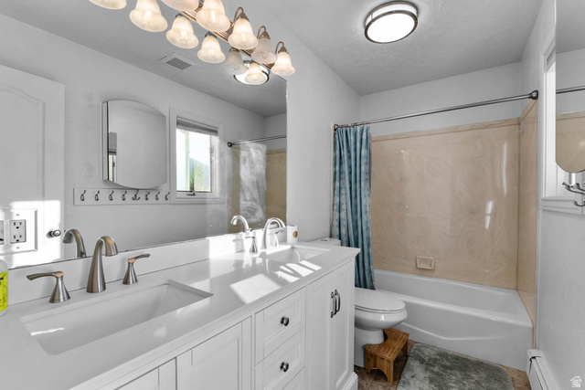 10686 South Covered Brg Cyn Road, Unit 14 Spanish Fork, UT 84660 - Photo 33 of 44 Bathroom featuring a dual vanity with integrated sinks, brushed nickel fixtures, and white cabinetry
