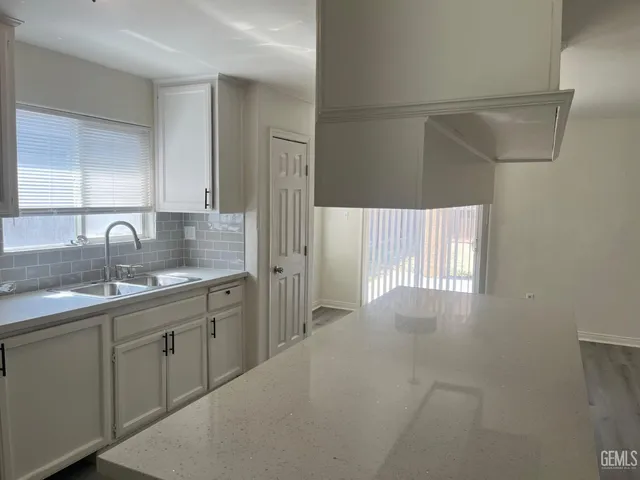 a kitchen with a sink and cabinets