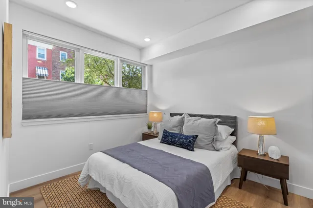 a bedroom with a bed and wooden floor