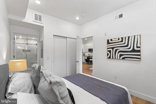 a bedroom with a bed and a lamp