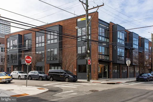 a view of a cars parked on the side of a street