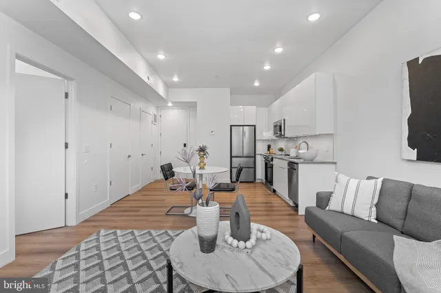 a living room with stainless steel appliances furniture