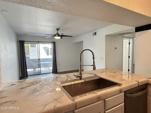 a kitchen with a sink and a large window