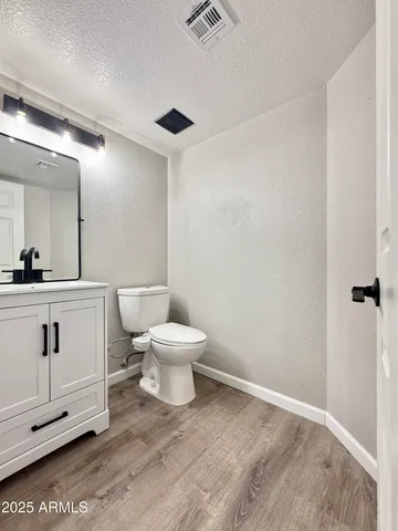 a white toilet sitting next to a bathroom sink