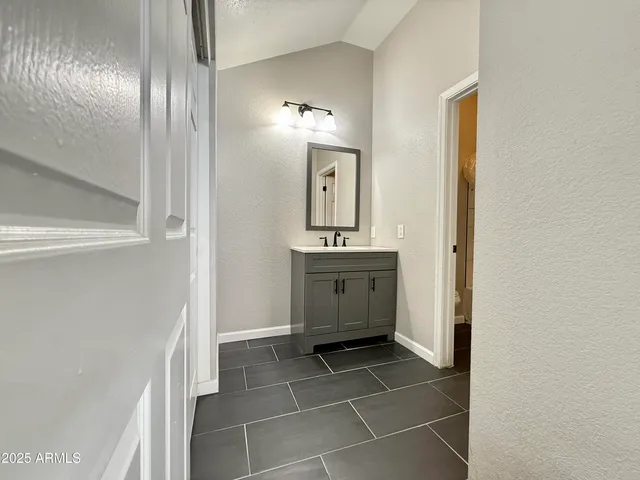 a bathroom with a sink a toilet and mirror