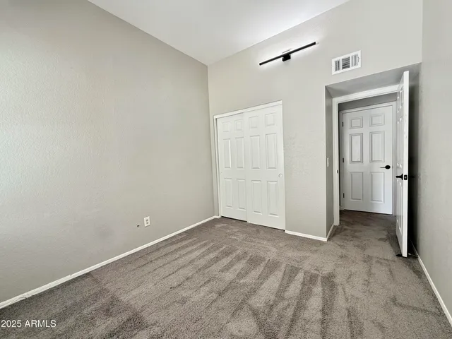 an empty room with closet area