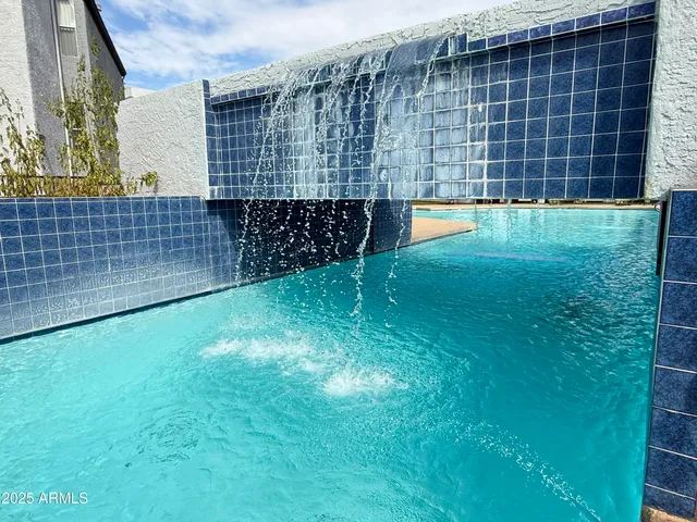 a backyard of a house with barbeque oven and outdoor seating