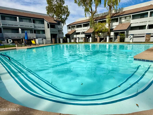 a view of a house with swimming pool and sitting area
