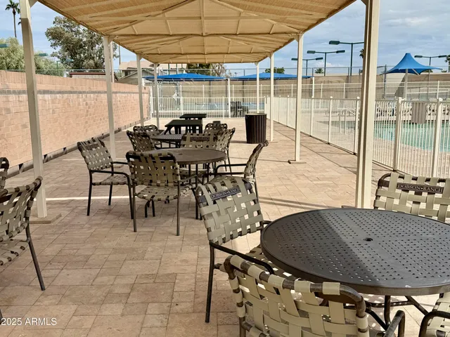 a view of a backyard with a patio and deck