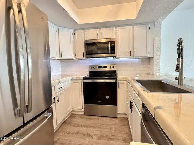 a kitchen with a sink stove and microwave