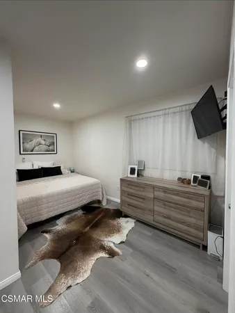 a bedroom with furniture and window