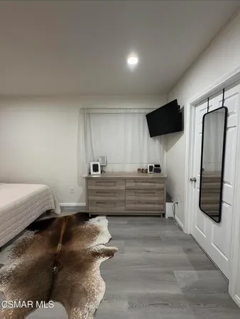 a room with a bed and a television