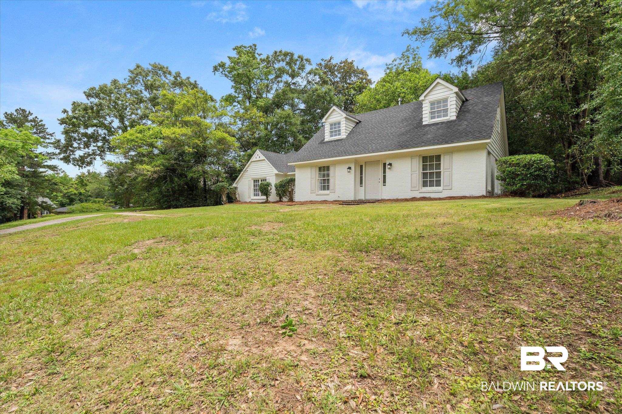 810 Nassau Drive Mobile, AL 36608 - Photo 21 of 31 Cape cod house featuring a front lawn, brick siding, and a shingled roof
