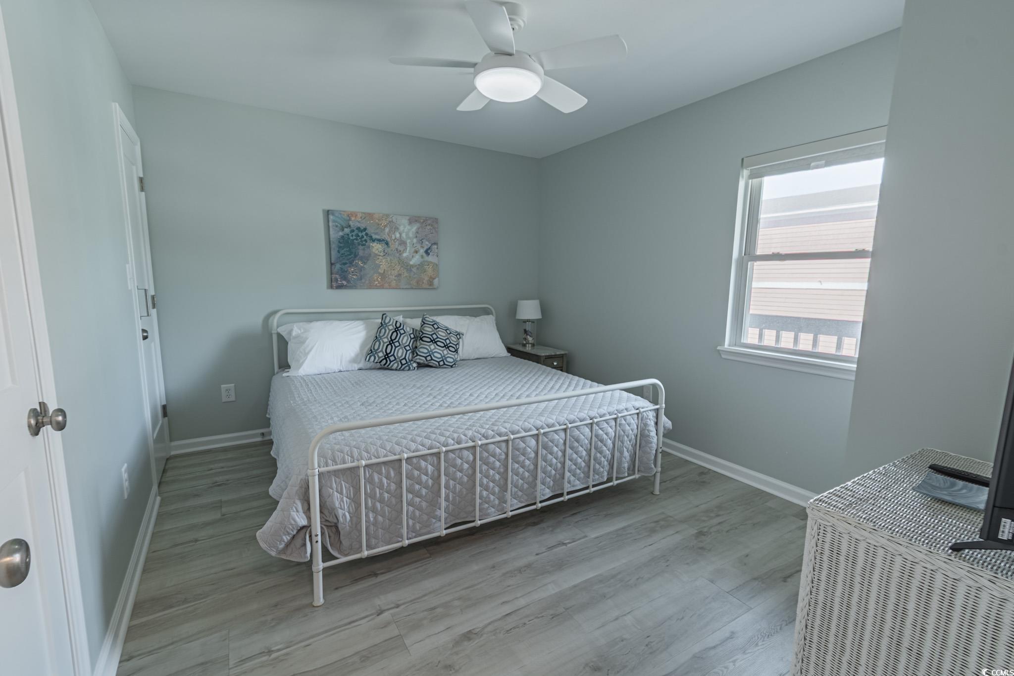 1210 North Ocean Boulevard, Unit 203 Surfside Beach, SC 29575 - Photo 15 of 27 Bedroom with light wood-style flooring and ceiling fan