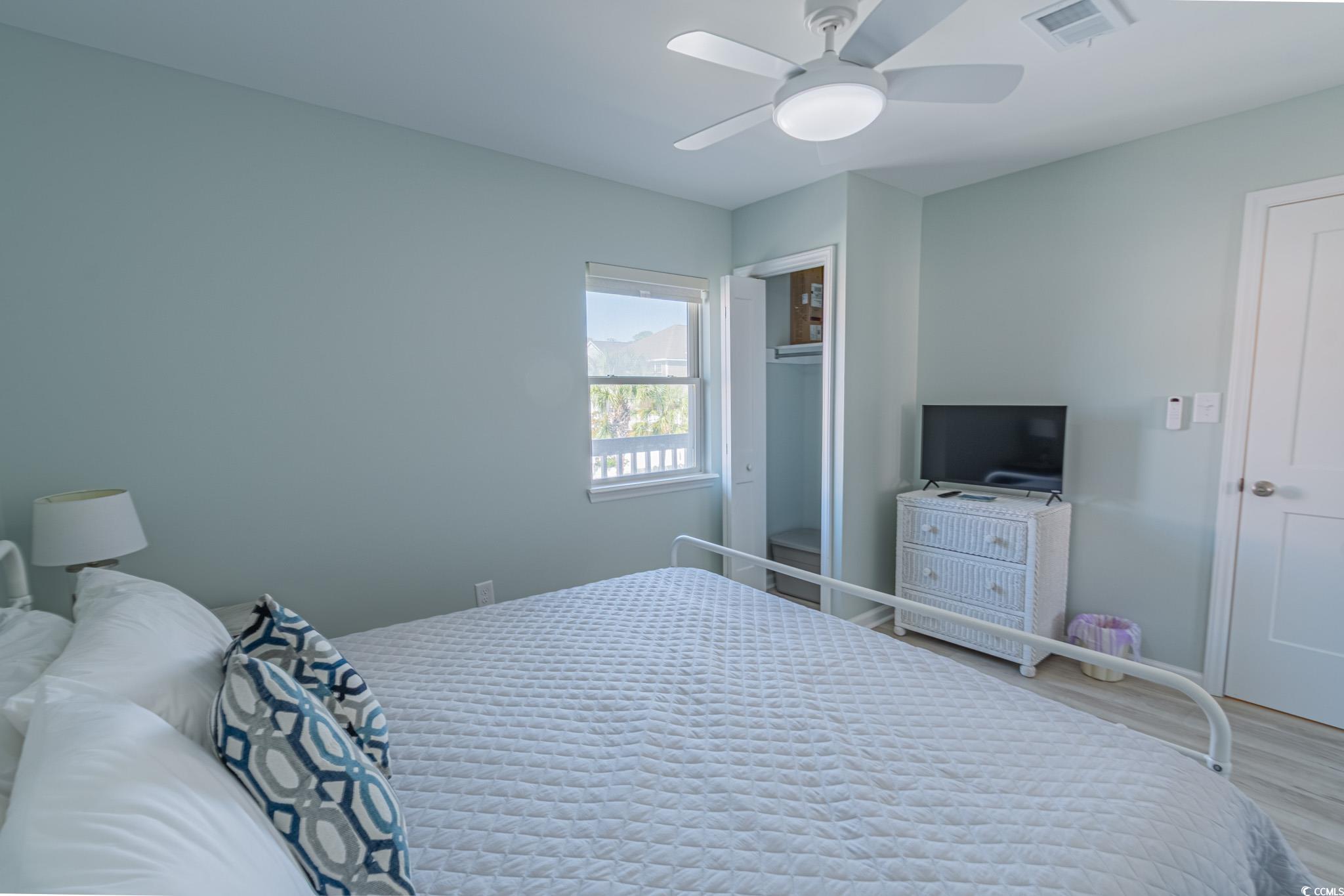 1210 North Ocean Boulevard, Unit 203 Surfside Beach, SC 29575 - Photo 16 of 27 Bedroom with a ceiling fan and wood finished floors