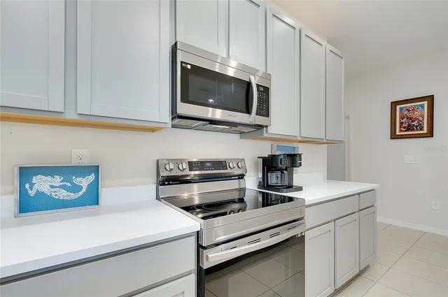 a living room with furniture kitchen view and a wooden floor