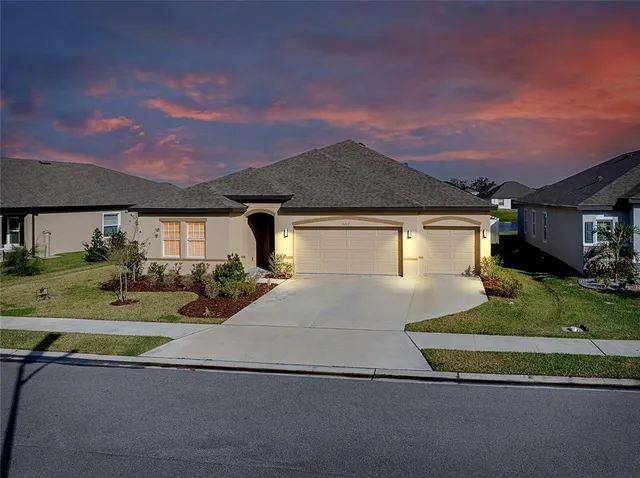 a front view of a house with a yard and garage