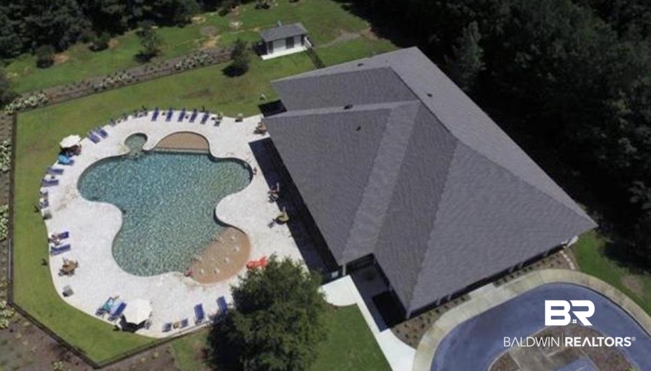 8137 Pine Run Daphne, AL 36527 - Photo 62 of 67 Expansive outdoor amenity area featuring a large freeform pool, surrounding concrete decking, and perimeter landscaping