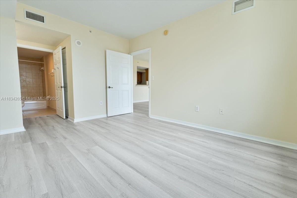 4242 Northwest 2nd Street, Unit 1601 Miami, FL 33126 - Photo 13 of 37 wooden floor in an empty room