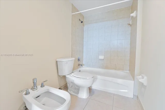 a bathroom with a toilet sink and shower