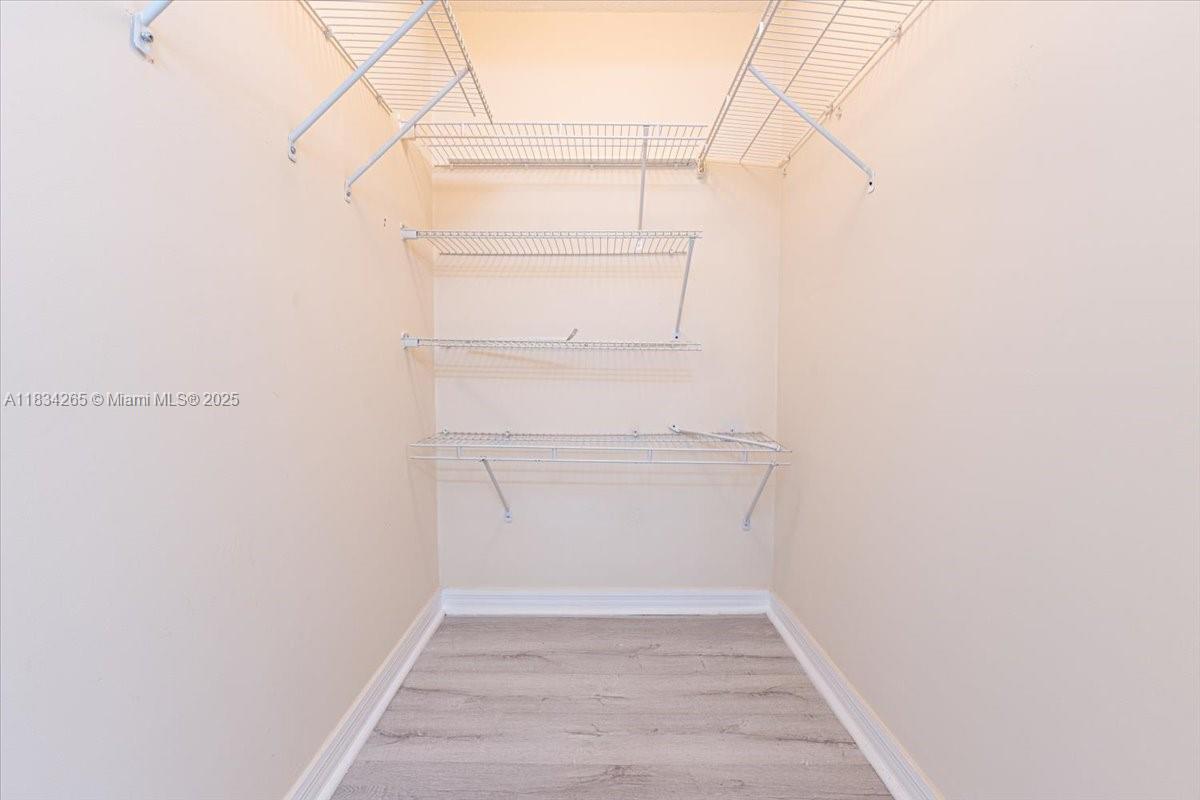 4242 Northwest 2nd Street, Unit 1601 Miami, FL 33126 - Photo 17 of 37 a view of walk in closet with empty racks