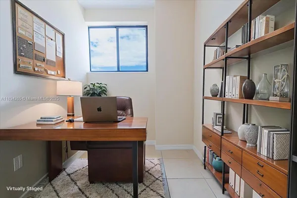 a room with furniture a rug and a potted plant