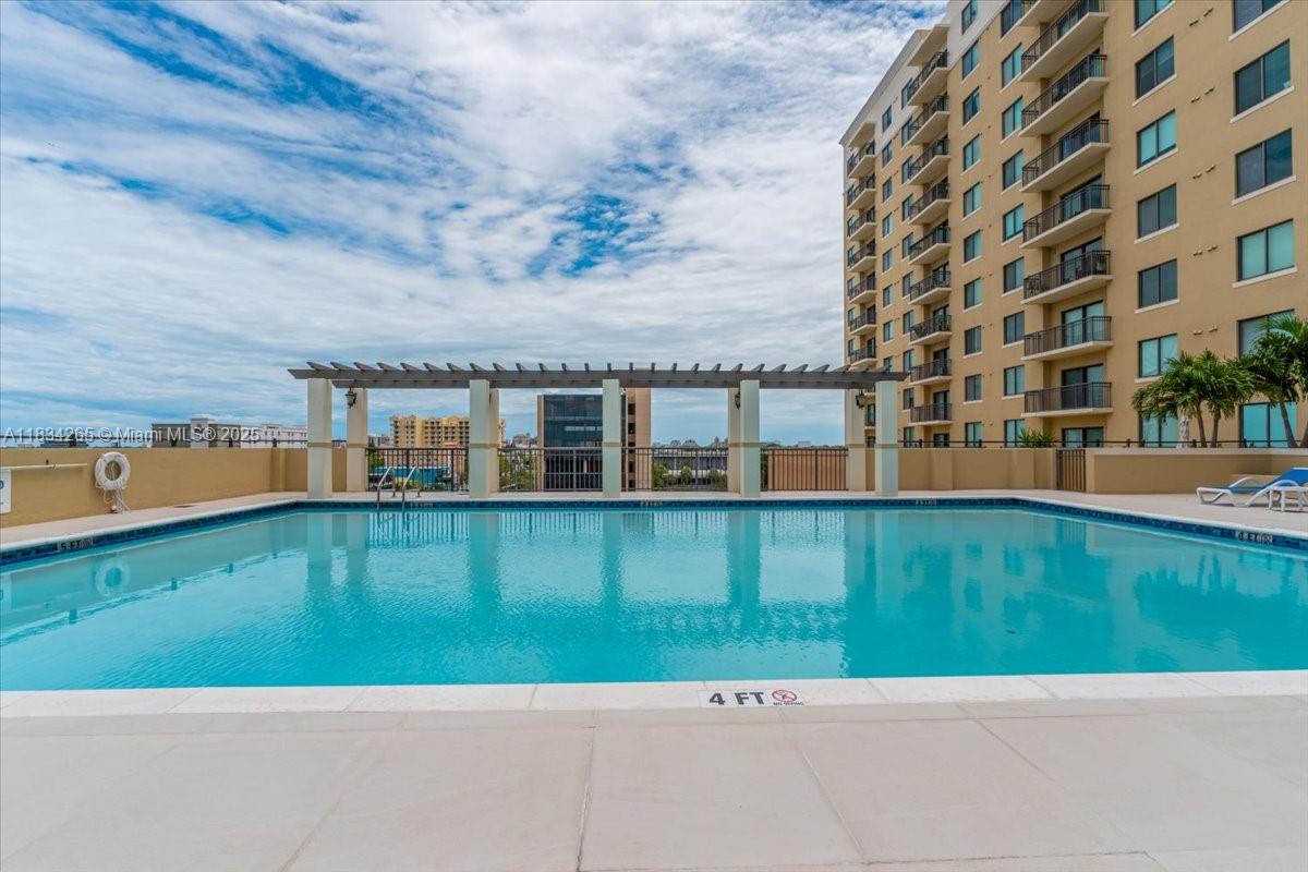 4242 Northwest 2nd Street, Unit 1601 Miami, FL 33126 - Photo 27 of 37 a front view of a house with a garden and lake view